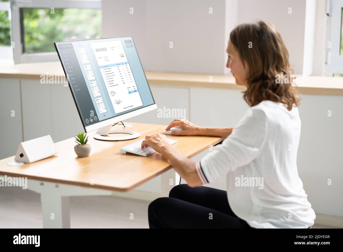 Accountant Using E Invoice Software At Computer In Office Stock Photo ...