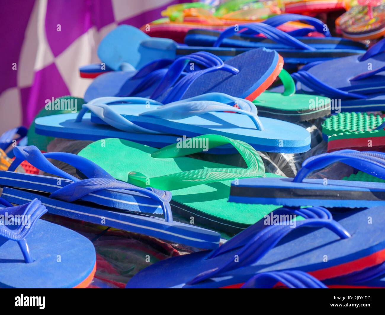 Pile of slippers at street stall. Slippers also called as hawai chappal in India. Stock Photo