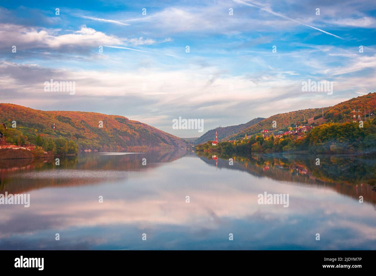 mountain lake somesul cald at sunset. beautiful autumnal countryside landscape of cluj country, romania. trees on the hill in colorful foliage and clo Stock Photo