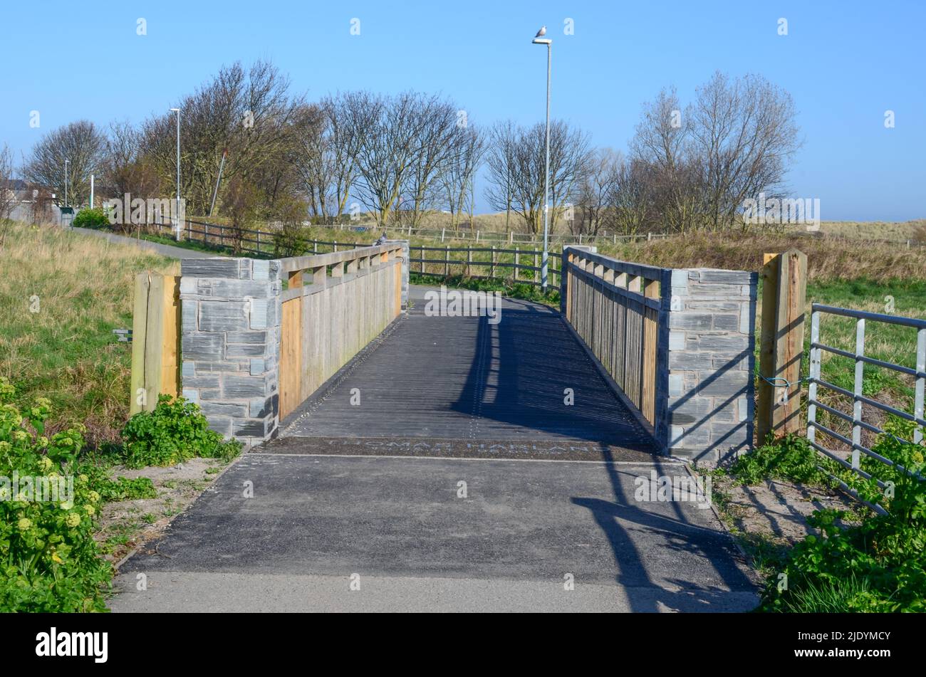 Prestatyn, UK: Mar 27, 2022: A wooden footbridge on the outskirts of Prestatyn is dedicated to Thomas Harland who lost his life in a road accident whi Stock Photo