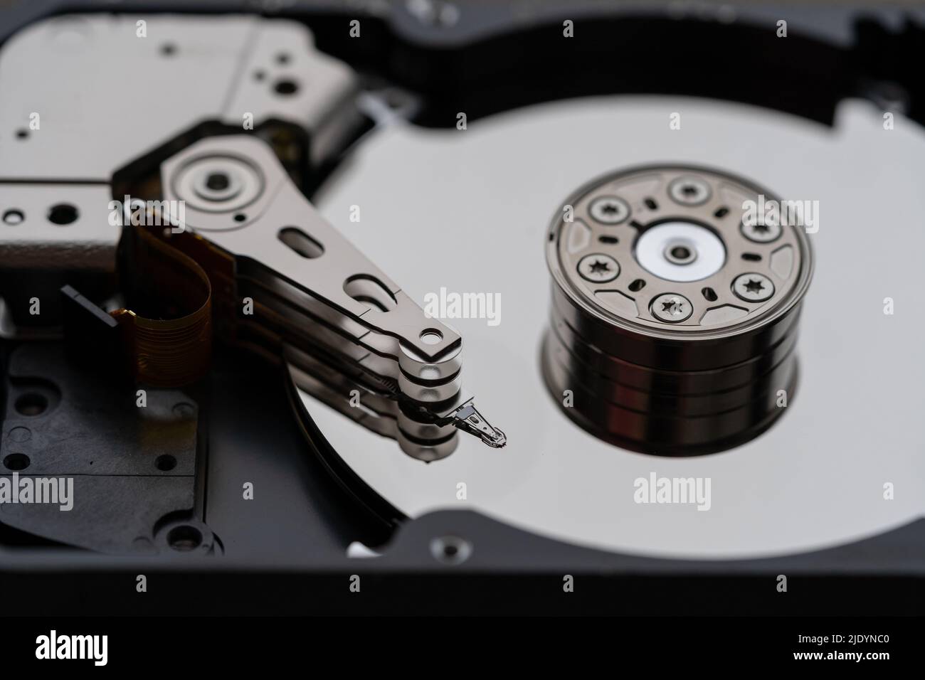 Opened hard disk after disassembly during repair or service, macro shot. Computer laptop HDD inside. Stock Photo