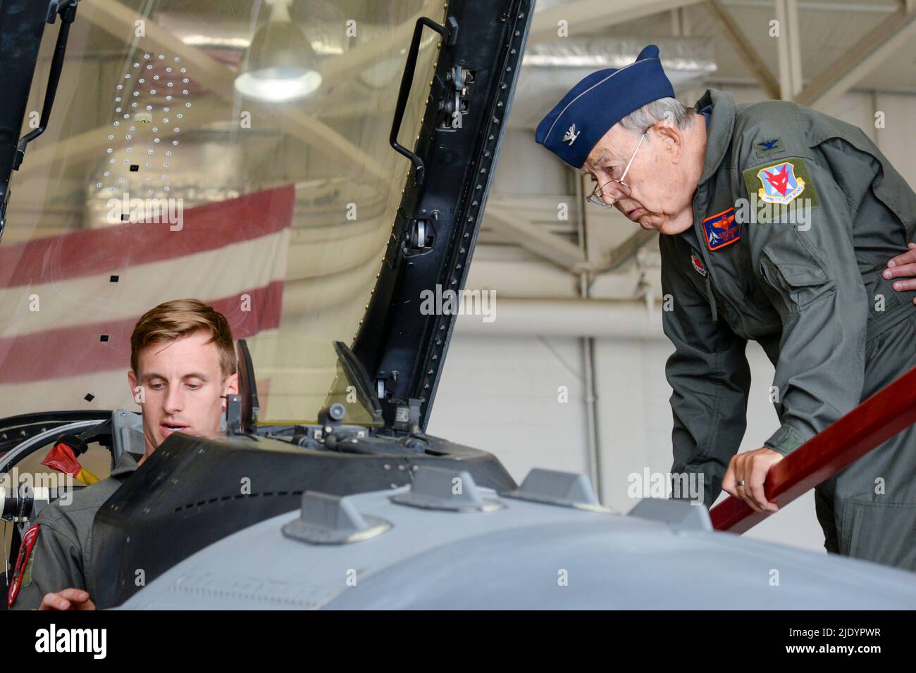 May 26, 2022 - Egg Harbor Township, New Jersey, USA - Retired U.S. Air Force Col. Ron Standerfer, North American F-100 Super Sabre pilot and Vietnam War veteran, right, speaks to Capt. Jordan 'Fuze' Dahl, 119th Fighter Squadron F-16C Fighting Falcon pilot, left, about the F-16C May 26, 2022, at the Atlantic City Air National Guard Base, Egg Harbor Township, New Jersey. The F-100F static display at the 177th FW, 56-3897, is on loan from the National Museum of the USA Air Force and was dedicated to Standerfer for his service in Vietnam. (Credit Image: © U.S. Air Force/ZUMA Press Wire Service/ZUM Stock Photo