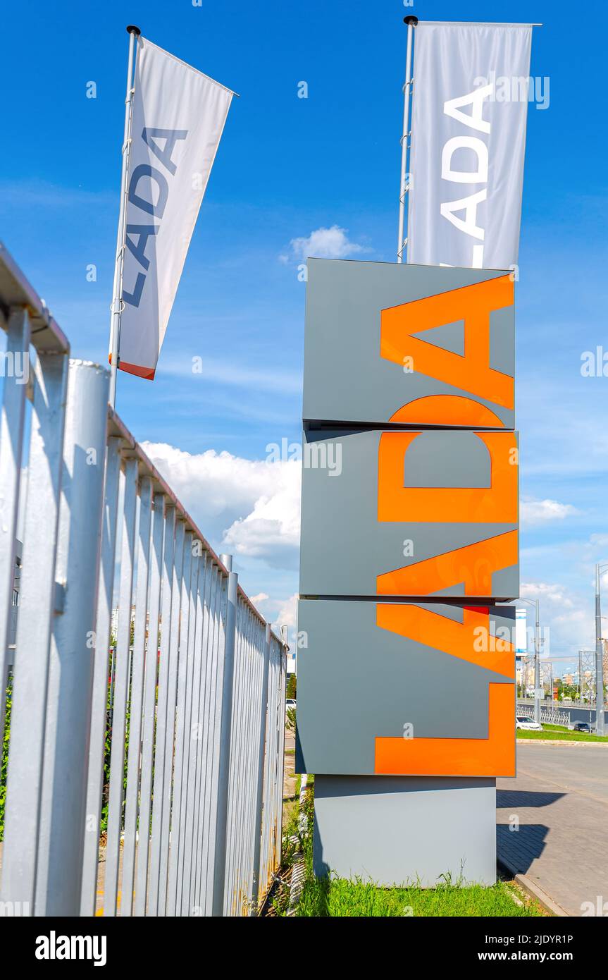 Samara, Russia - June 18, 2022: Dealership signboard and flags of official dealer Lada.  Lada is a Russian automobile manufacturer Stock Photo