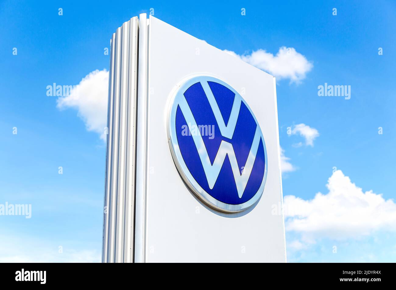 Samara, Russia - June 18, 2022: Dealership sign with the logo of Volkswagen against the blue sky. Volkswagen is the biggest German automaker Stock Photo