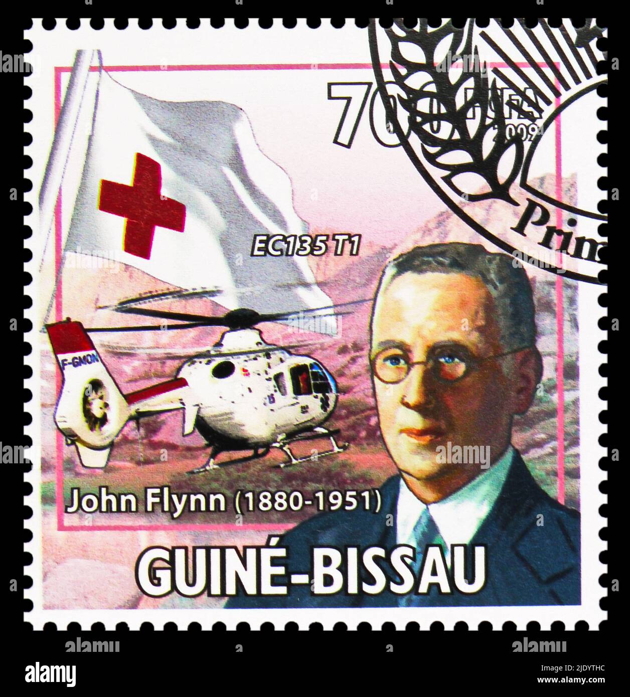 MOSCOW, RUSSIA - JUNE 17, 2022: Postage stamp printed in Guinea-Bissau shows John Flynn and EC135 T1, serie, circa 2009 Stock Photo