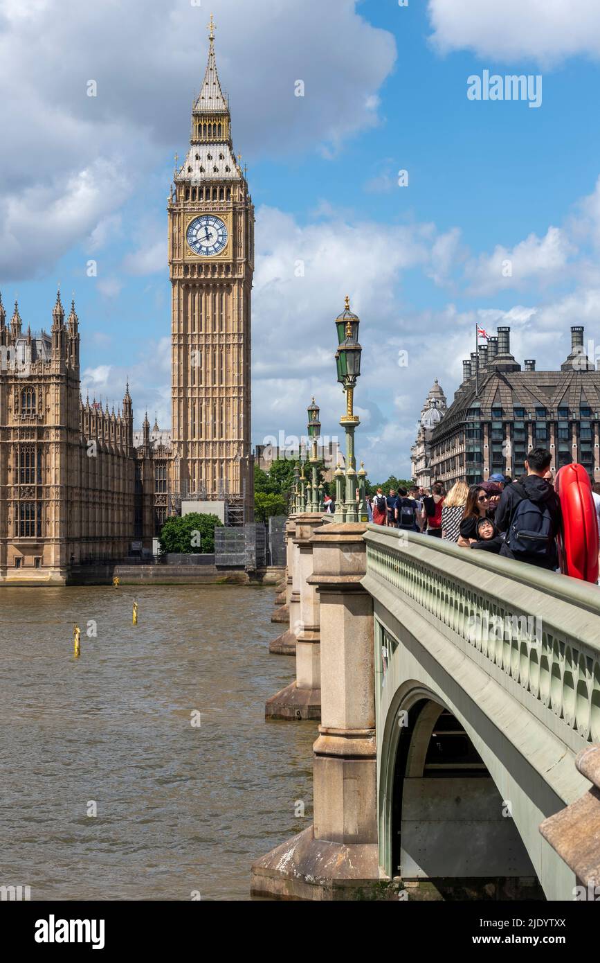Elizabeth Tower, Big Ben, of the Palace of Westminster, alongside Westminster Bridge, London, UK. River Thames crossing. People on bridge Stock Photo