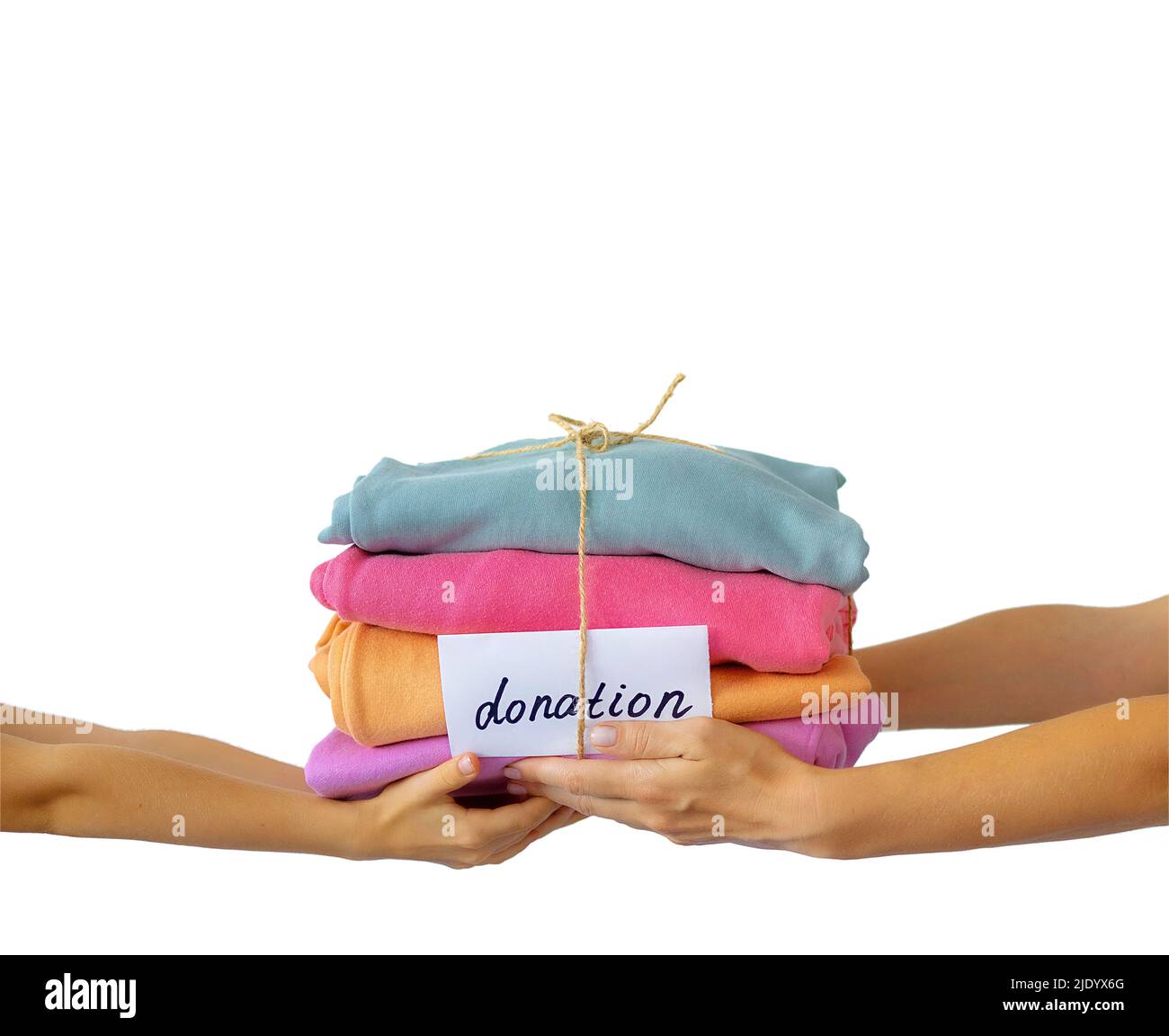 Women's hand give a stack of clothes to children's hands. Helping the poor, helping those in need. Clothes Donation, Renewable Concept. Stock Photo
