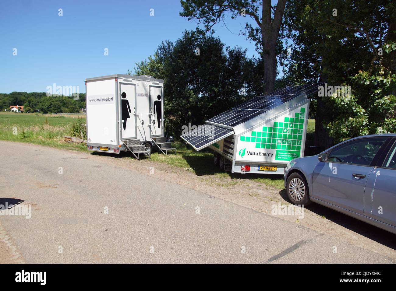 Mobile power generator, solar generator from Volta Energy, with solar panels. For construction. Double portable toilet cabin. June, Netherlands Bergen Stock Photo