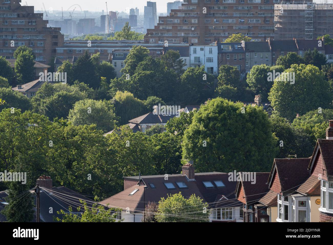 The city is seen from from the hilltop of Westwood Park, beyond housing and residential properties across south London, on 22nd June 2022, in London, England. Stock Photo