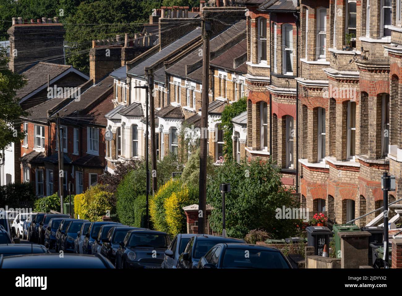 A south London residential street with homes leading downhill towards the city in the distance, at Crystal Palace in south London, on 22nd June 2022, in London, England. Stock Photo
