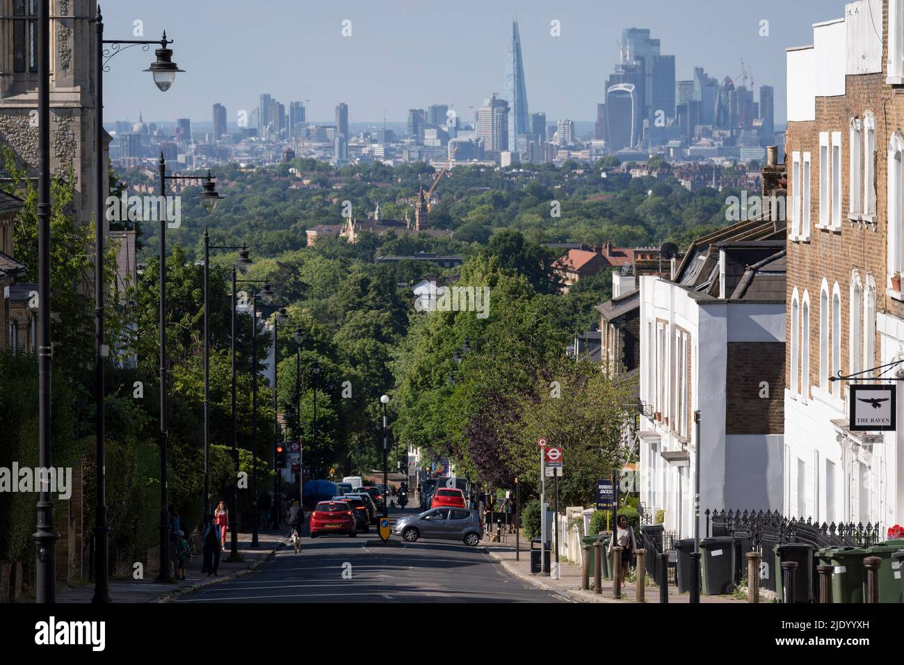 A south London residential street with homes leading downhill towards the city in the distance, at Crystal Palace in south London, on 22nd June 2022, in London, England. Stock Photo