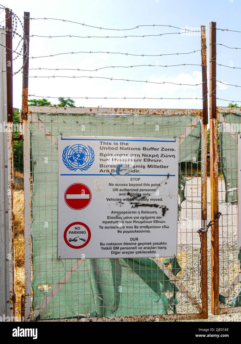 Fenced-off entrance to the UN Buffer Zone in Nicosia, Cyprus bearing a trilingual warning notice Stock Photo