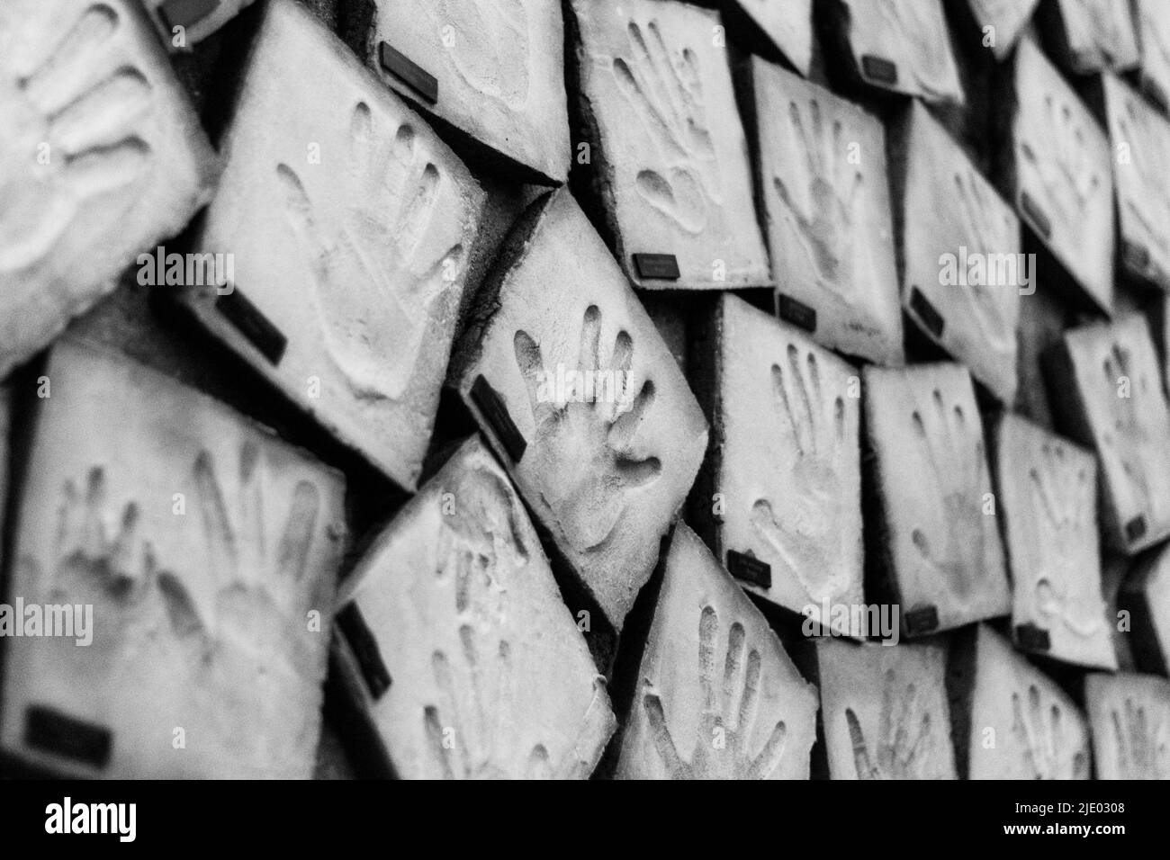 Wall covered with hand molds, humanity, memoirs of social life. Human wall of hands. Community mural with hands of children's, mankind. Stock Photo