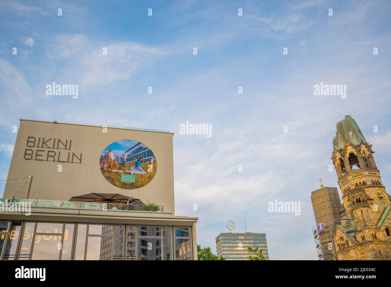 Berlin, Germany, June 2022, Illustrative Editorial: View on Bikini Berlin Shopping Mall and Kapelle der Kaiser-Wilhelm-Gedachtniskirche Stock Photo