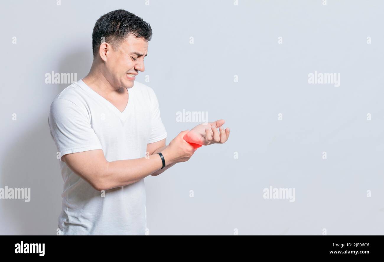 People with wrist pain isolated, concept of man with pain in the hands, man with arthritis rubbing, person with pain in the wrist, Concept of Stock Photo