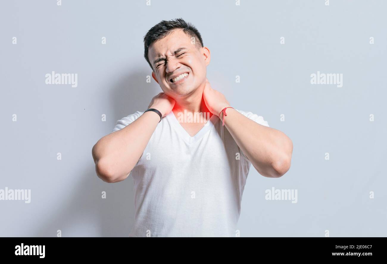 People with neck pain, a man with neck pain on isolated background, neck pain and stress concept, man with muscle pain Stock Photo