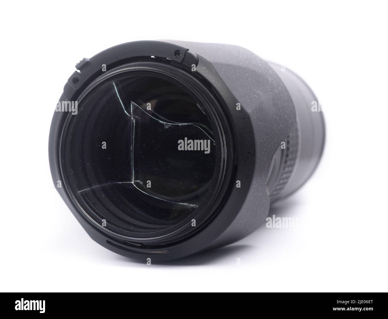 Broken protective filter glass on DSLR camera lens isolated over white