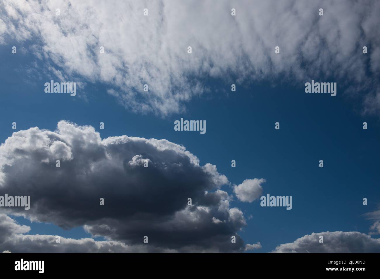 Detail of moody cumulus clouds in blue sky Stock Photo