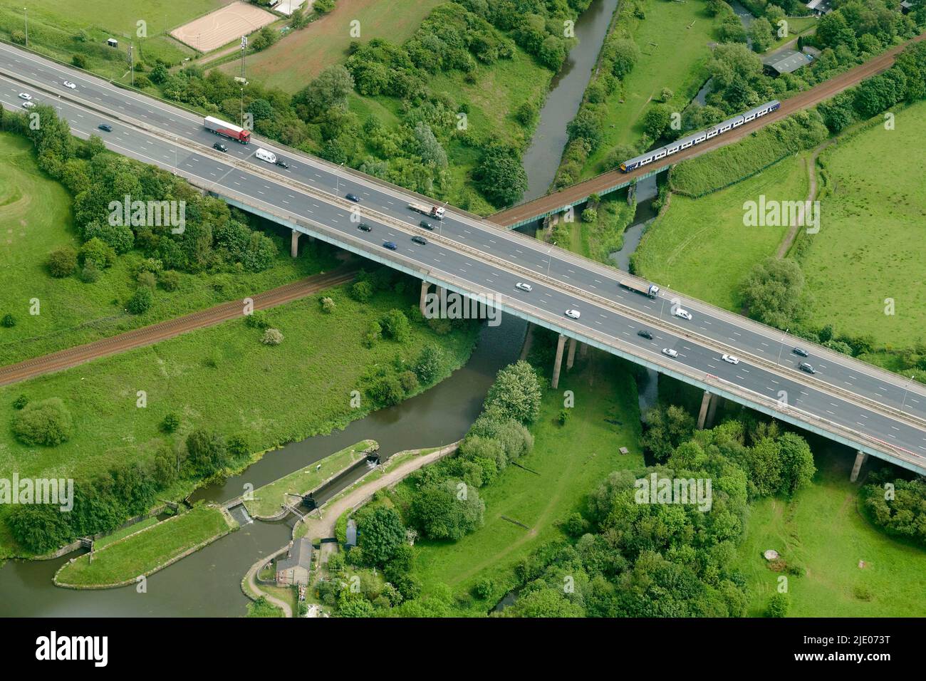 A unique images of three modes of transport, spanning 300 years, The Leeds Liverpool Canal, Rail and M6 Motorway, wigan, North West England UK Stock Photo