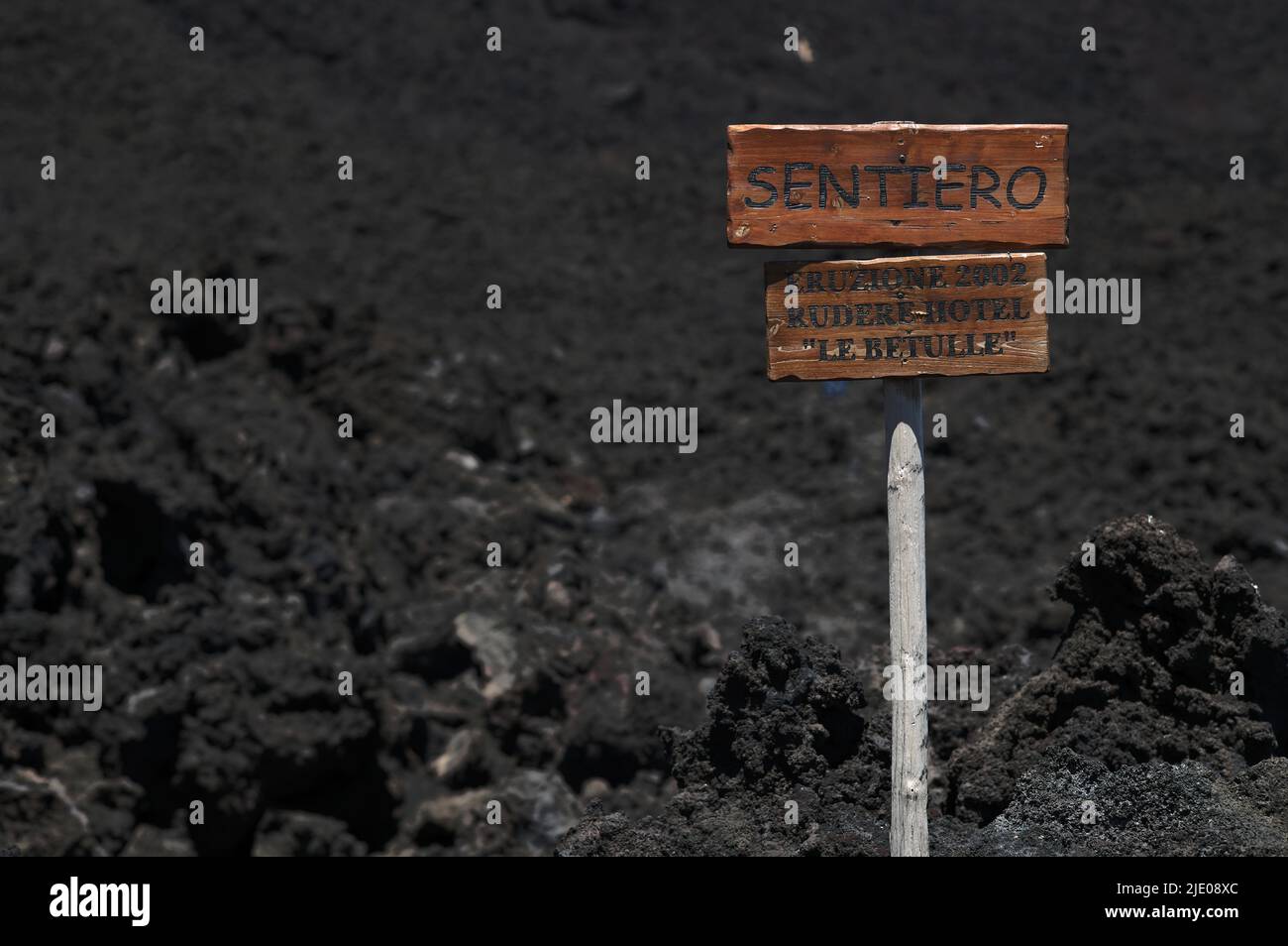 Signpost across lava field to Le Betulle hotel destroyed by eruption, 2002, Piano Provenzana Etna North, Etna volcano, Sicily, Italy Stock Photo