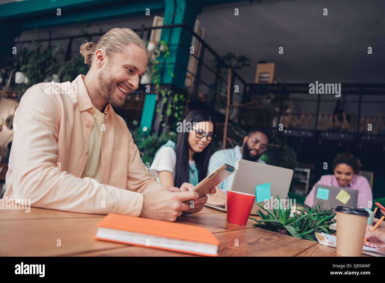 Photo of charming smiling businesswoman businessman creating new device
