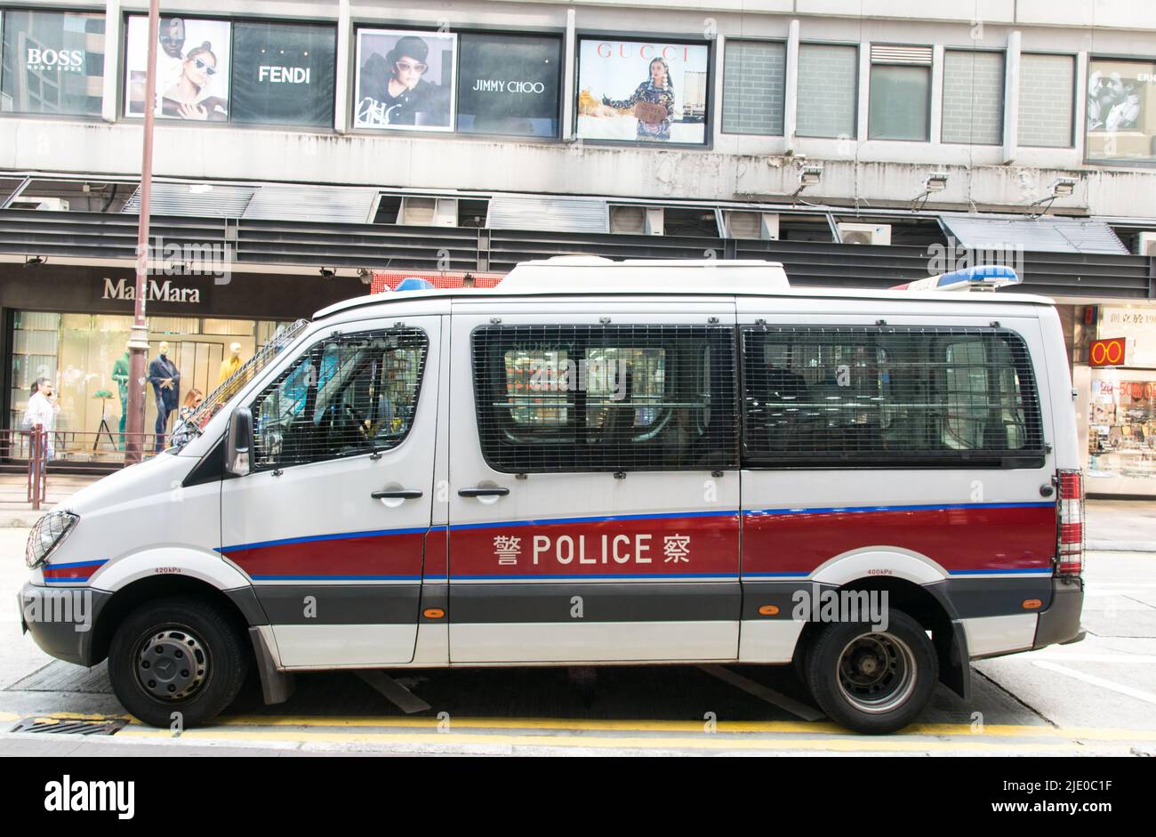 Hong Kong police vehicle on Peking road in Kowloon. the vehicle is Mercedes-Benz van and The windows are protected by bars. Stock Photo