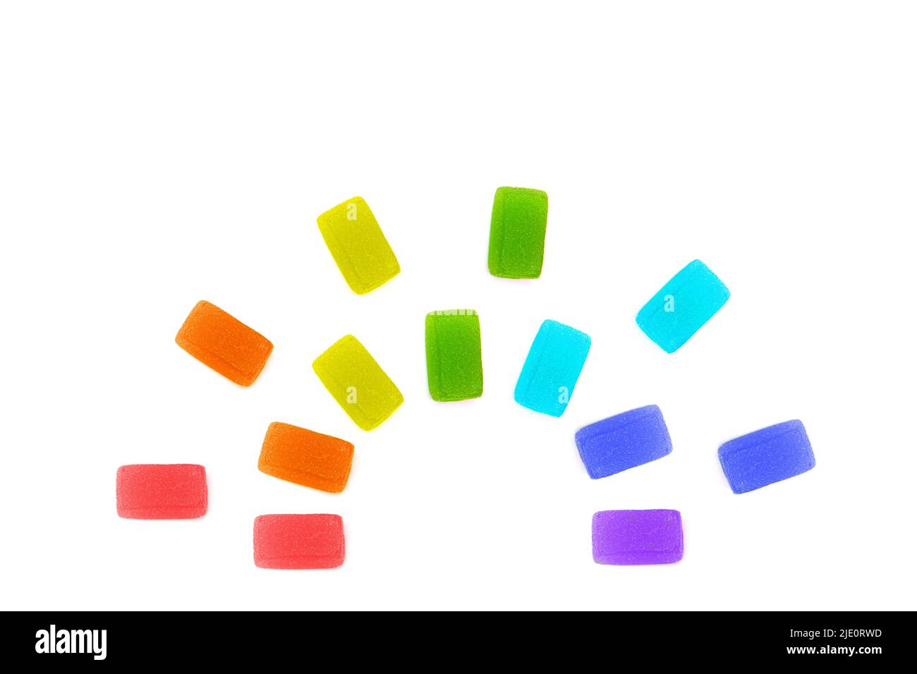 Fruit jelly cubes arranged into a rainbow shape isolated on white