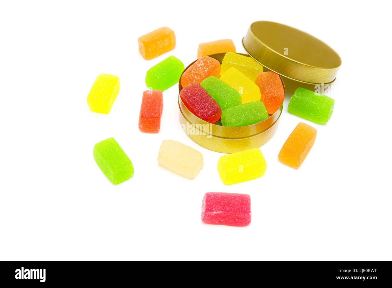 Delicious mixture of various fruit jelly cubes in a round tin candy box