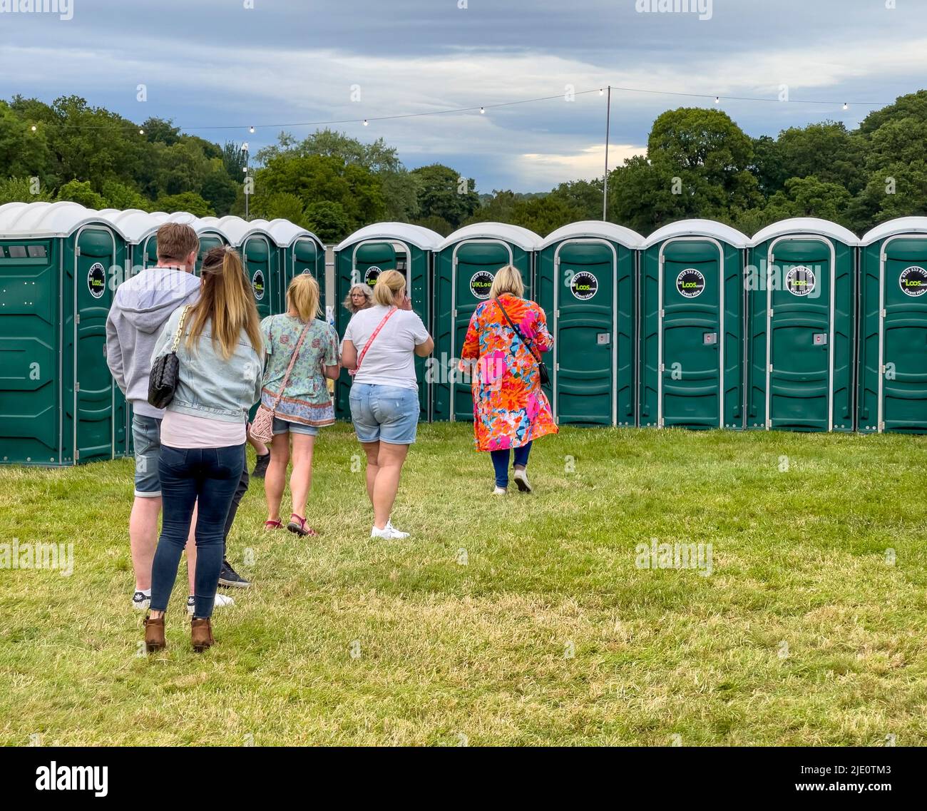 Queuing for the chemical toilets at an outdoor festival. Stock Photo