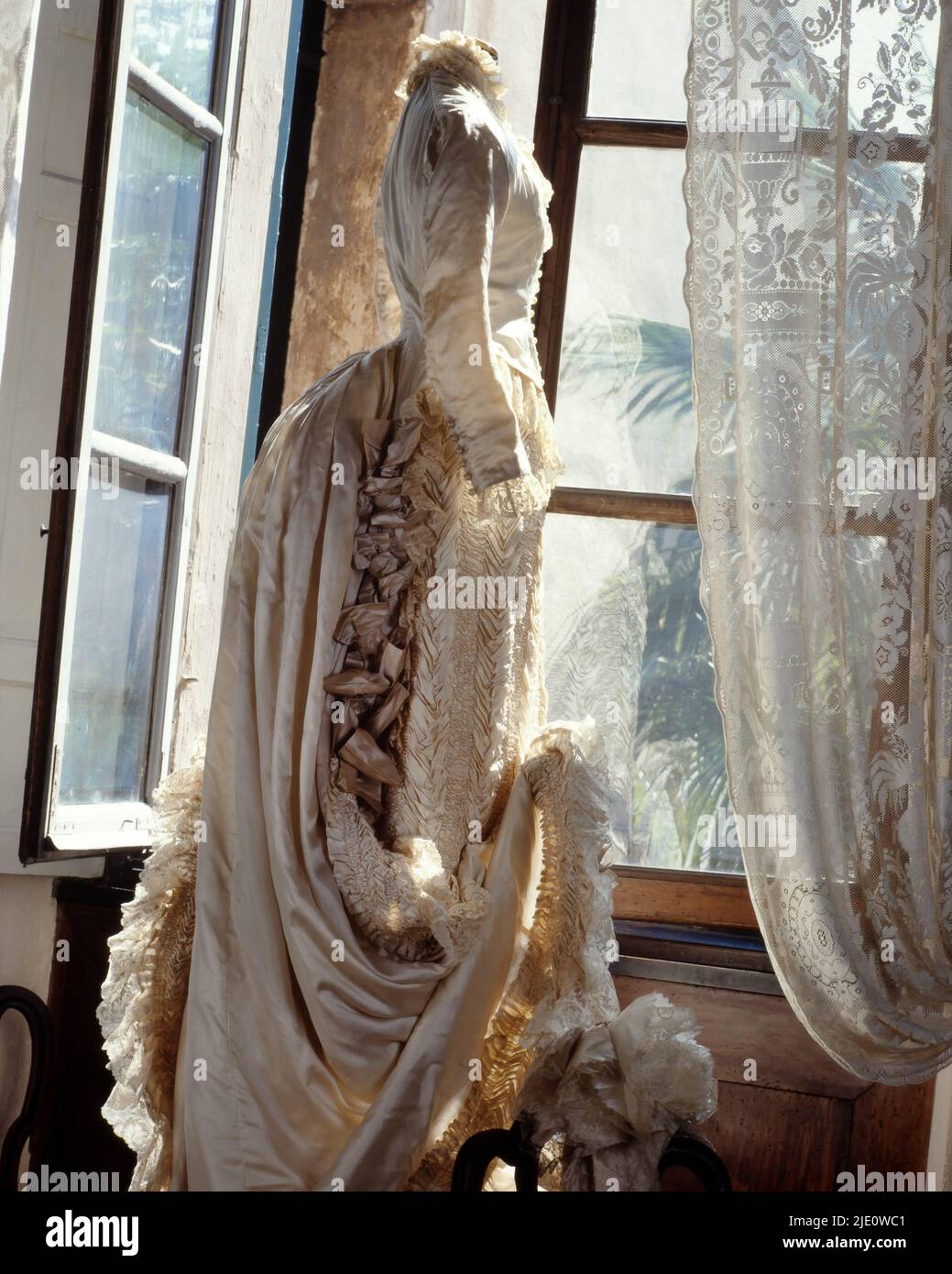 Bridal bouquet, Ancient wedding dresses in ‘Tapissier’ style, so-called for its side decorations, 1880. Stock Photo