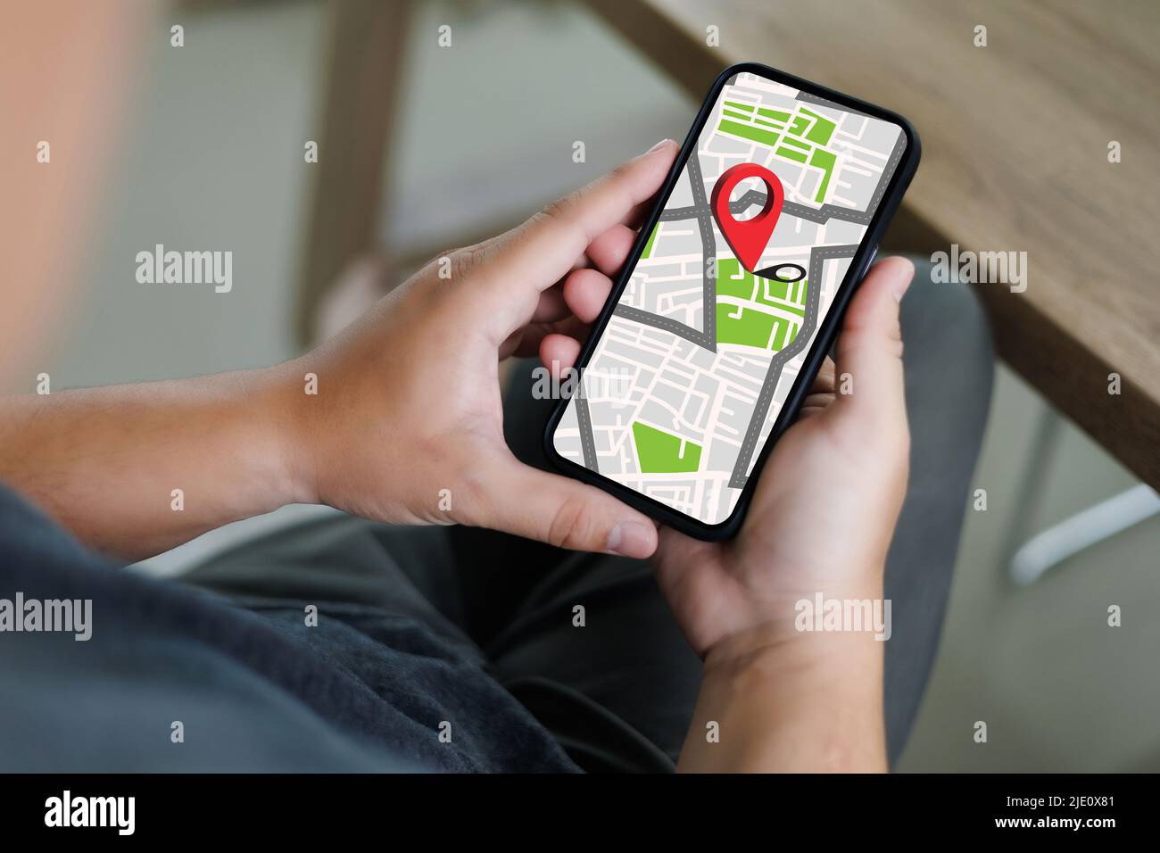hand using a smartphone Holding GPS Map to Route Destination network ...