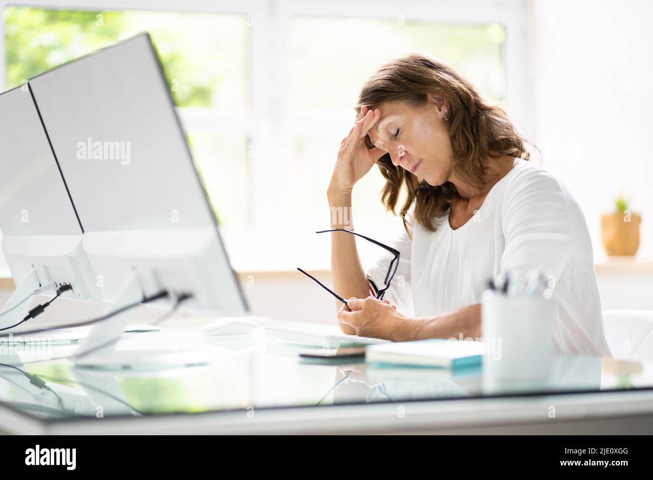 Stressed At Work. Tired Young Office Employee Worker Stock Photo