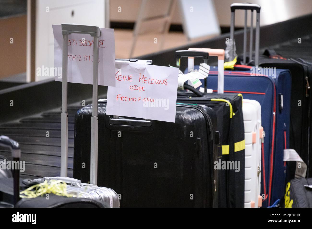 Hamburg, Germany. 23rd June, 2022. "No report or outside company" is  written on a note stuck to a suitcase. Hundreds of suitcases, bags and baby  carriages are still piled up in the