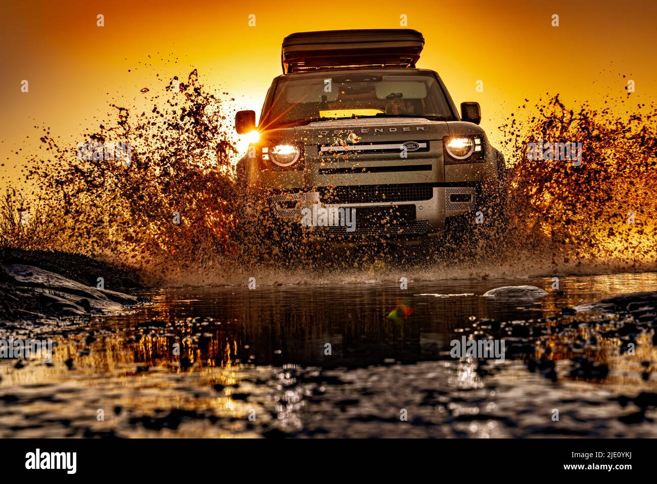 Rybachy, RUSSIA - May 30 2022: Off-roading New Land Rover Defender. The Land Rover Defender is a series of British off-road cars and pick-up trucks. Stock Photo