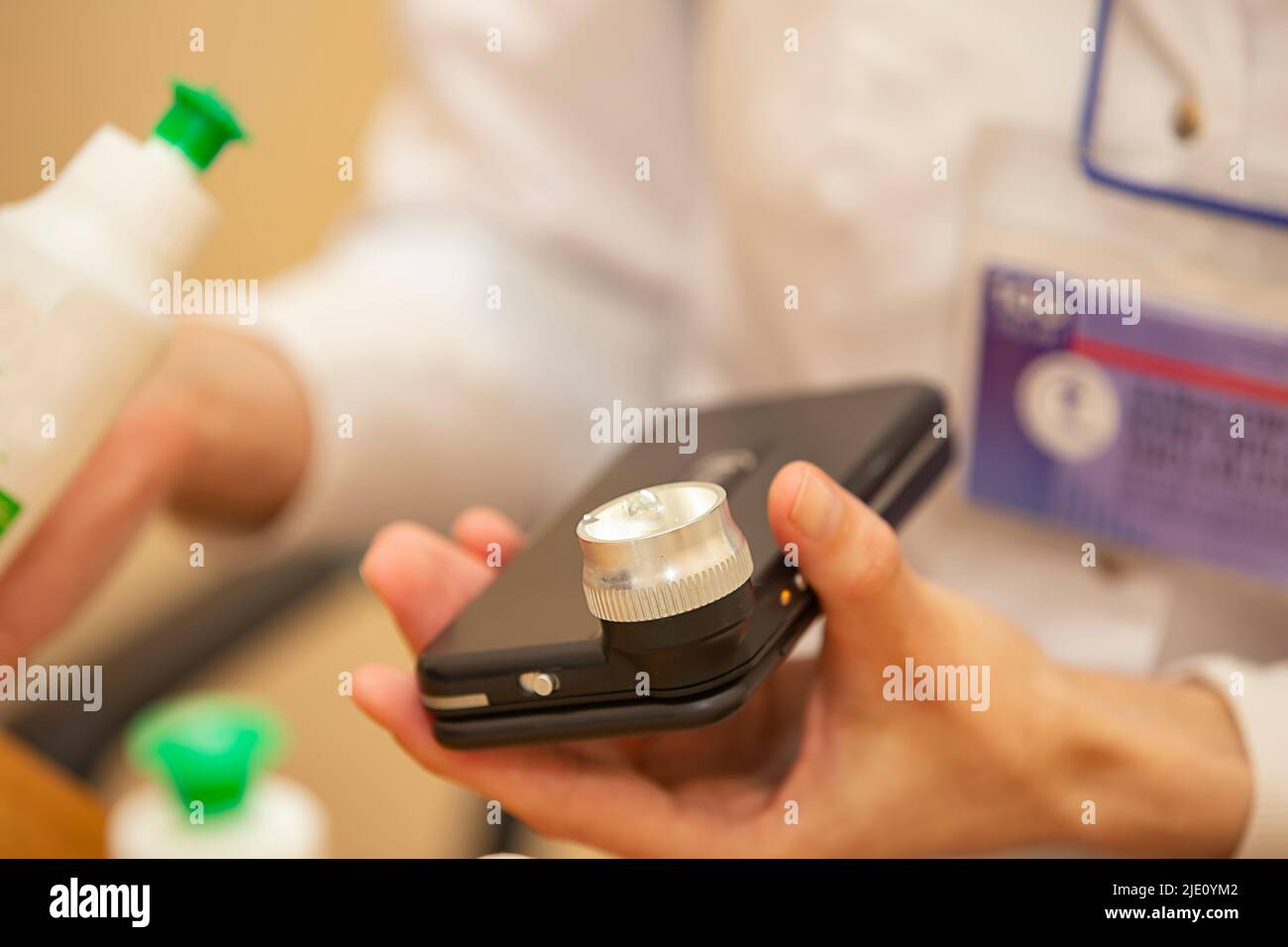 A dermatologist doctor treats with a solution of a modern device using