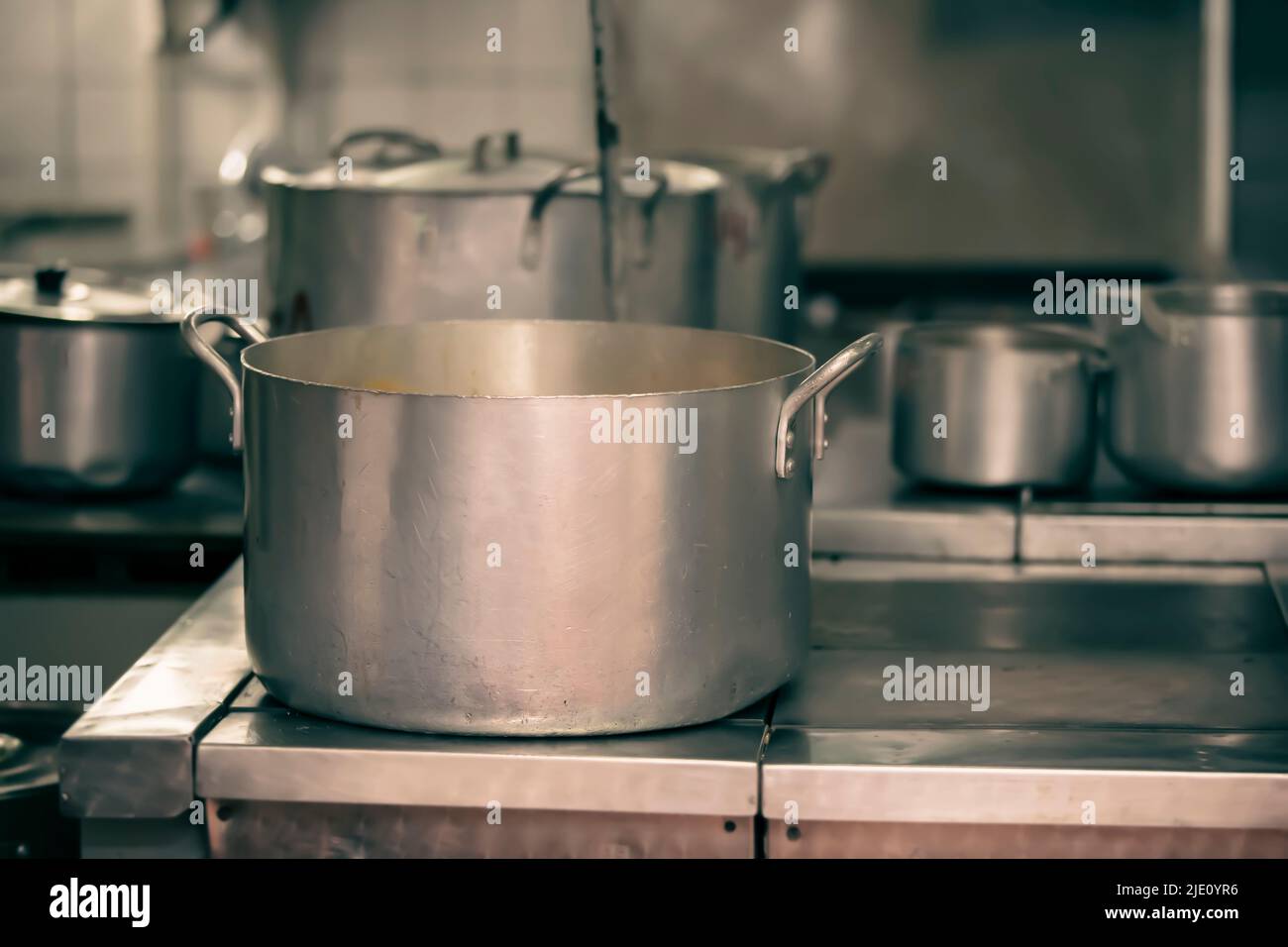 Cook with big cooking pot in the kitchen Stock Photo - Alamy