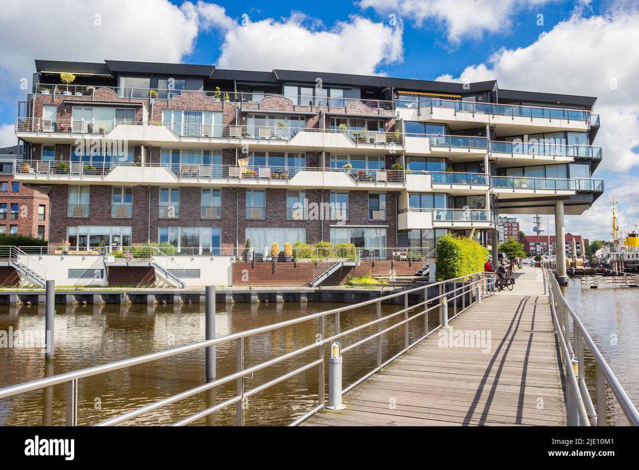 Wooden bridge and modern apartment building in Emden, Germany Stock