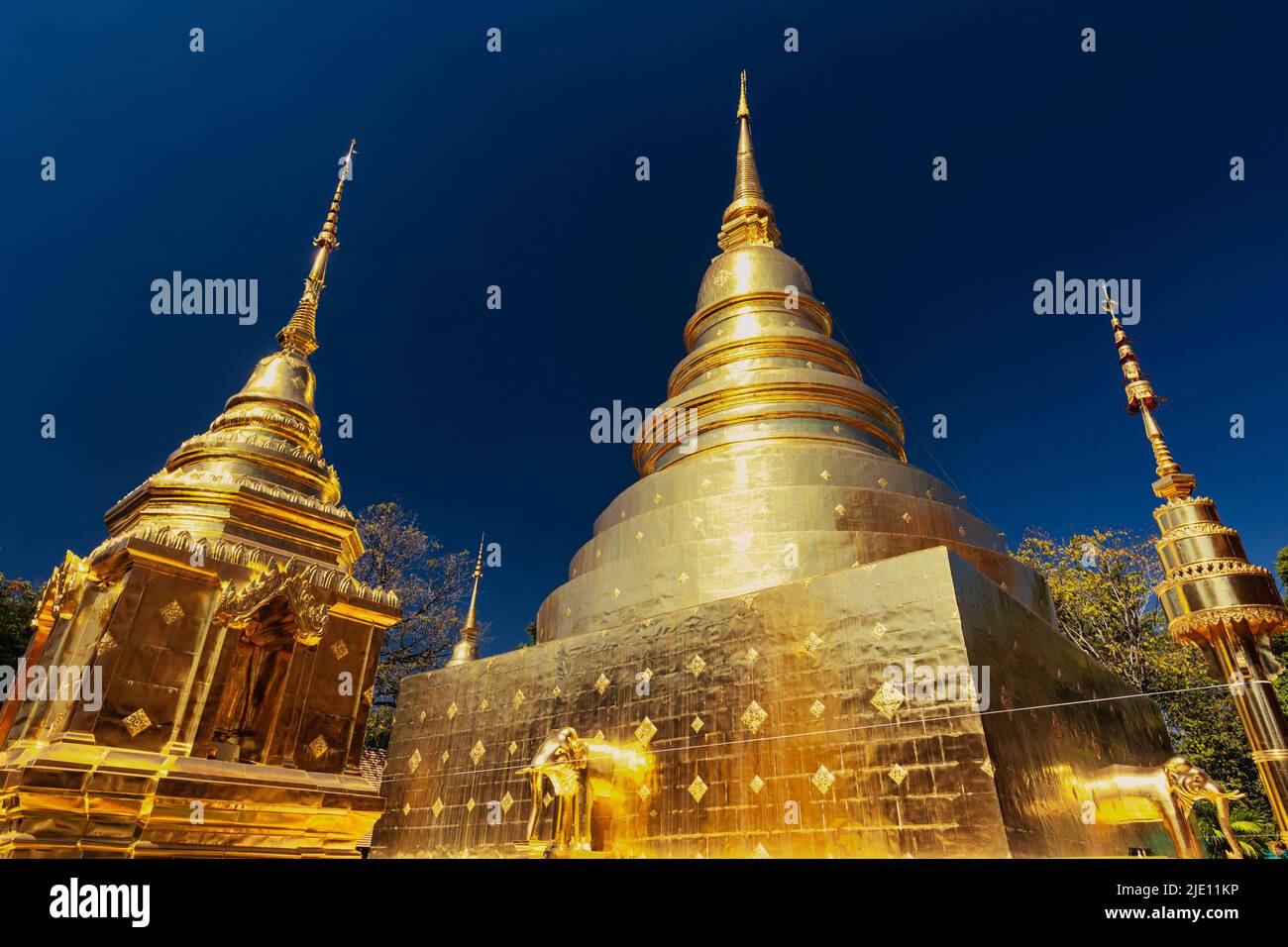 The gilded stupas of the Wat Phra Singh temple in Chiang Mai, Thailand Stock Photo
