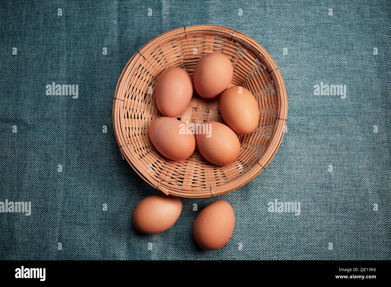 Chicken eggs in the wicker basket Stock Photo