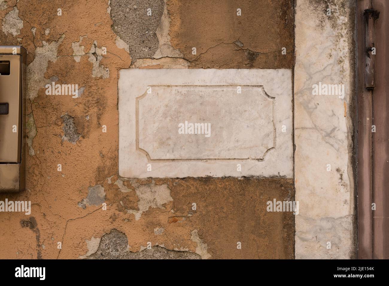 Blank marble plate on a yellow concrete old wall Stock Photo
