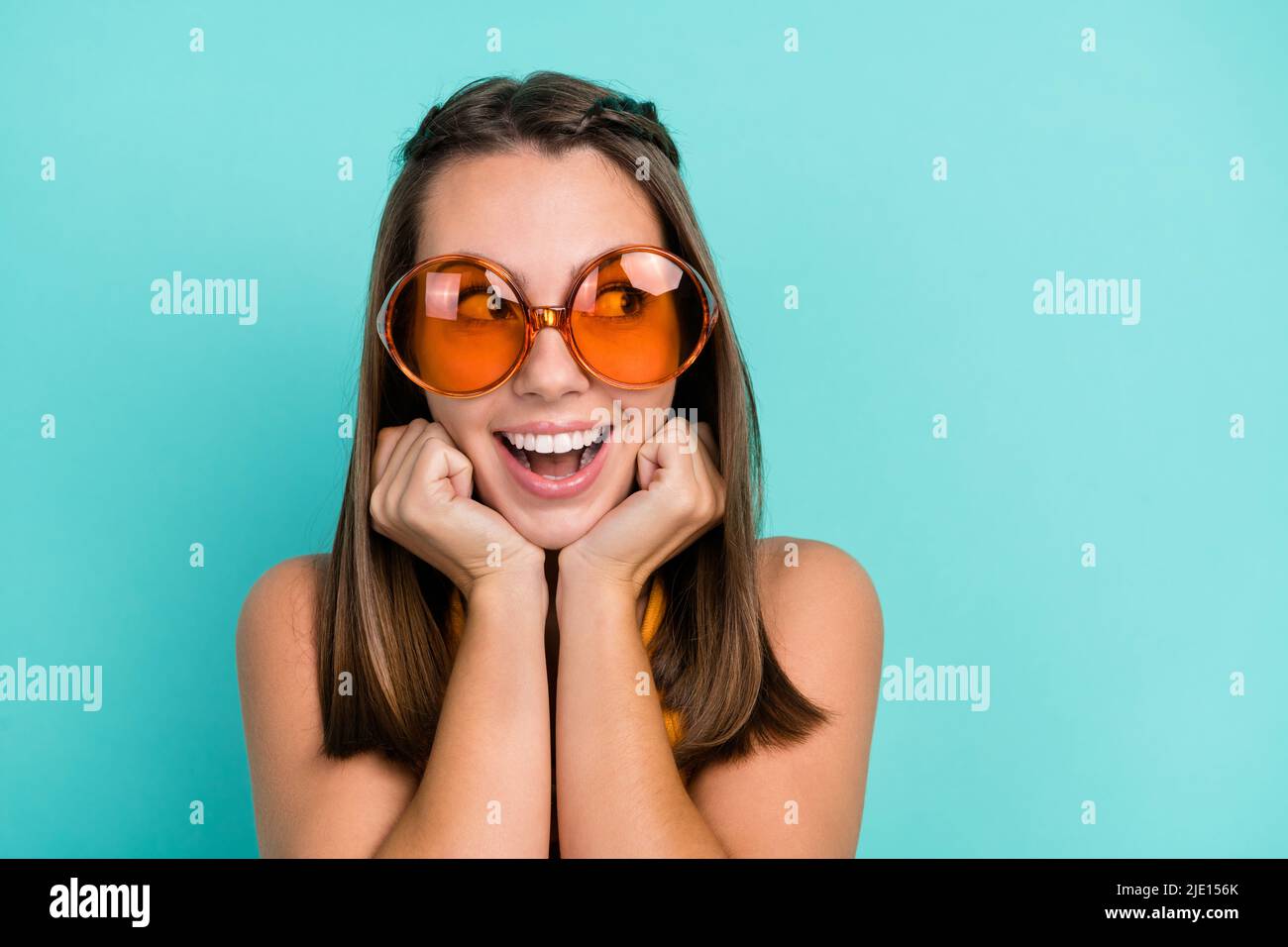 Photo of dreamy positive young happy woman hold hands face look empty ...