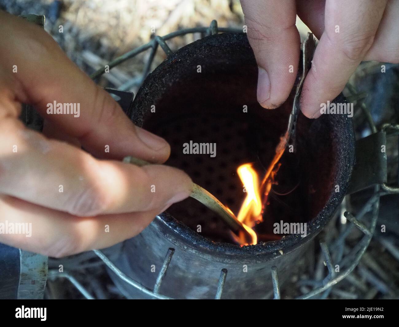 starting a bee smoker before harvesting honey hives in the farm Stock