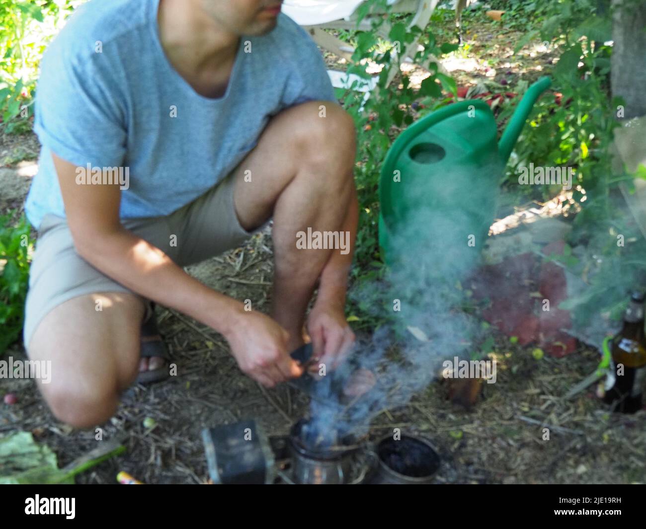 starting a bee smoker before harvesting honey hives in the farm Stock