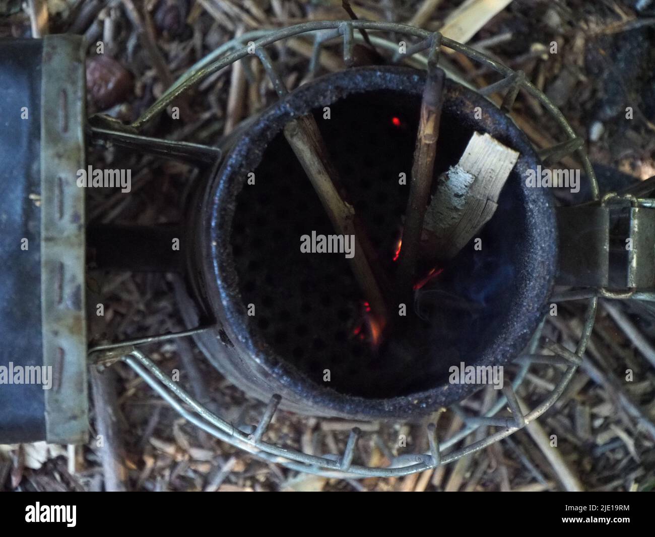 starting a bee smoker before harvesting honey hives in the farm Stock