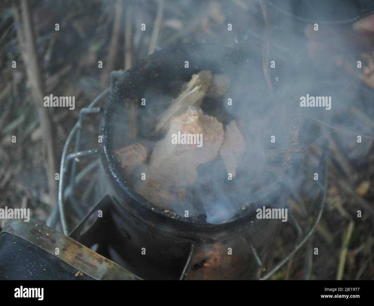 starting a bee smoker before harvesting honey hives in the farm Stock
