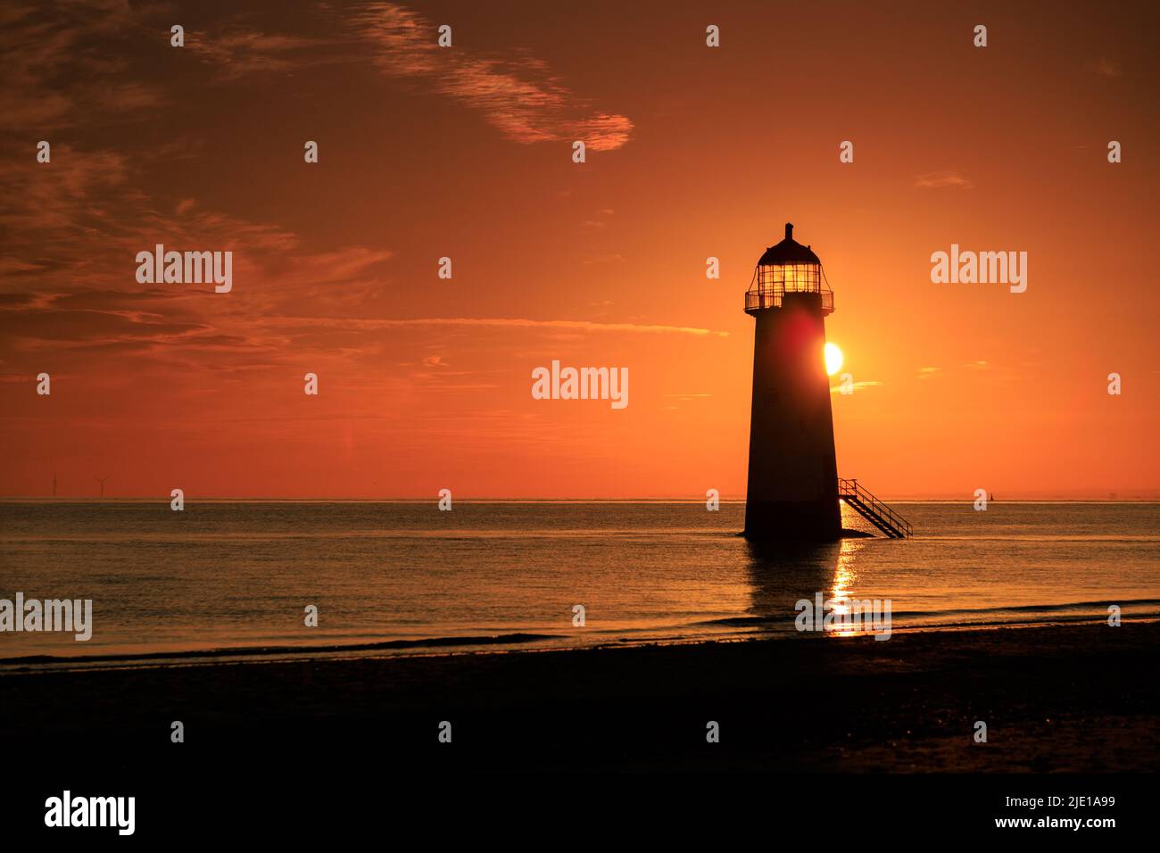 Sunrise over Talacre lighthouse on the North Wales coast Stock Photo