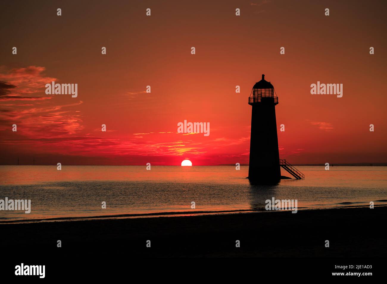 Sunrise over Talacre lighthouse on the North Wales coast Stock Photo