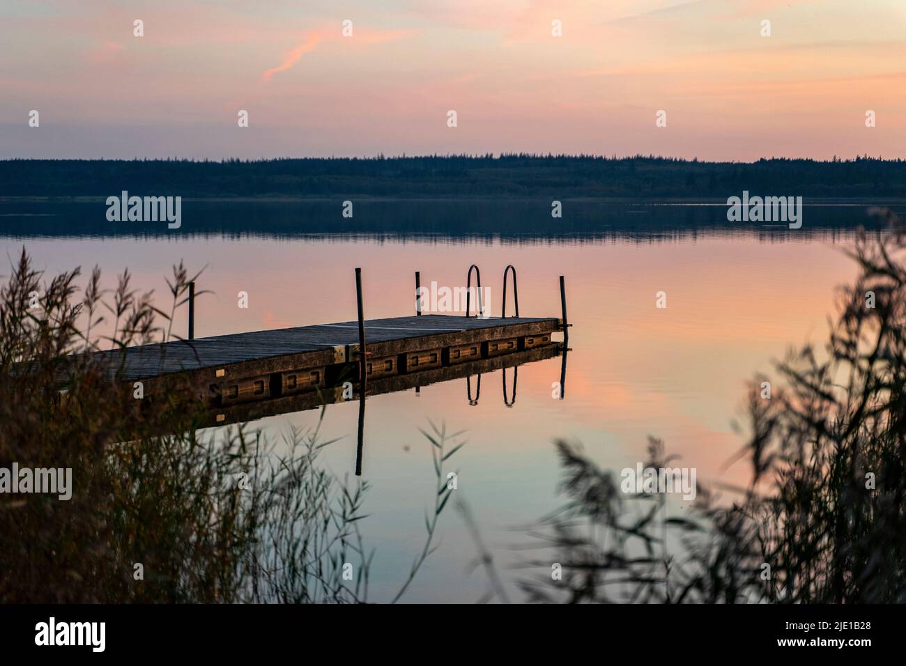 Dock in the Sunset at Vandet Lake, Denmark Stock Photo