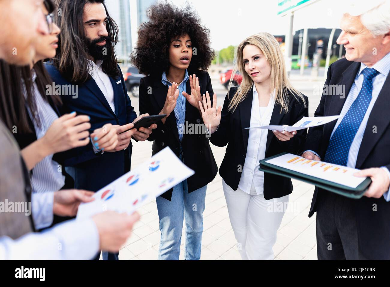 Multiracial business people having a briefing outside the office Stock Photo
