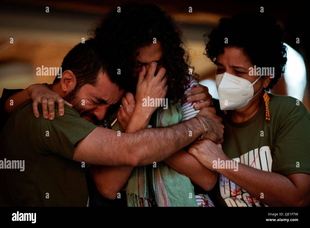 People are seen crying during an ecumenical act organized by indigenists and friends, in honor of the indigenous expert Bruno Pereira and journalist Dom Phillips, who were murdered in the Amazon, in Brasilia, Brazil June 24, 2022. REUTERS/Ueslei Marcelino Stock Photo